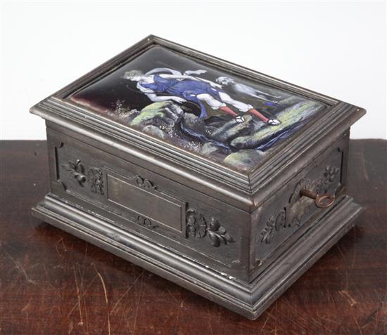 An early 19th century Limoges style enamel plaque set in a later carved ebonised casket, 7in.